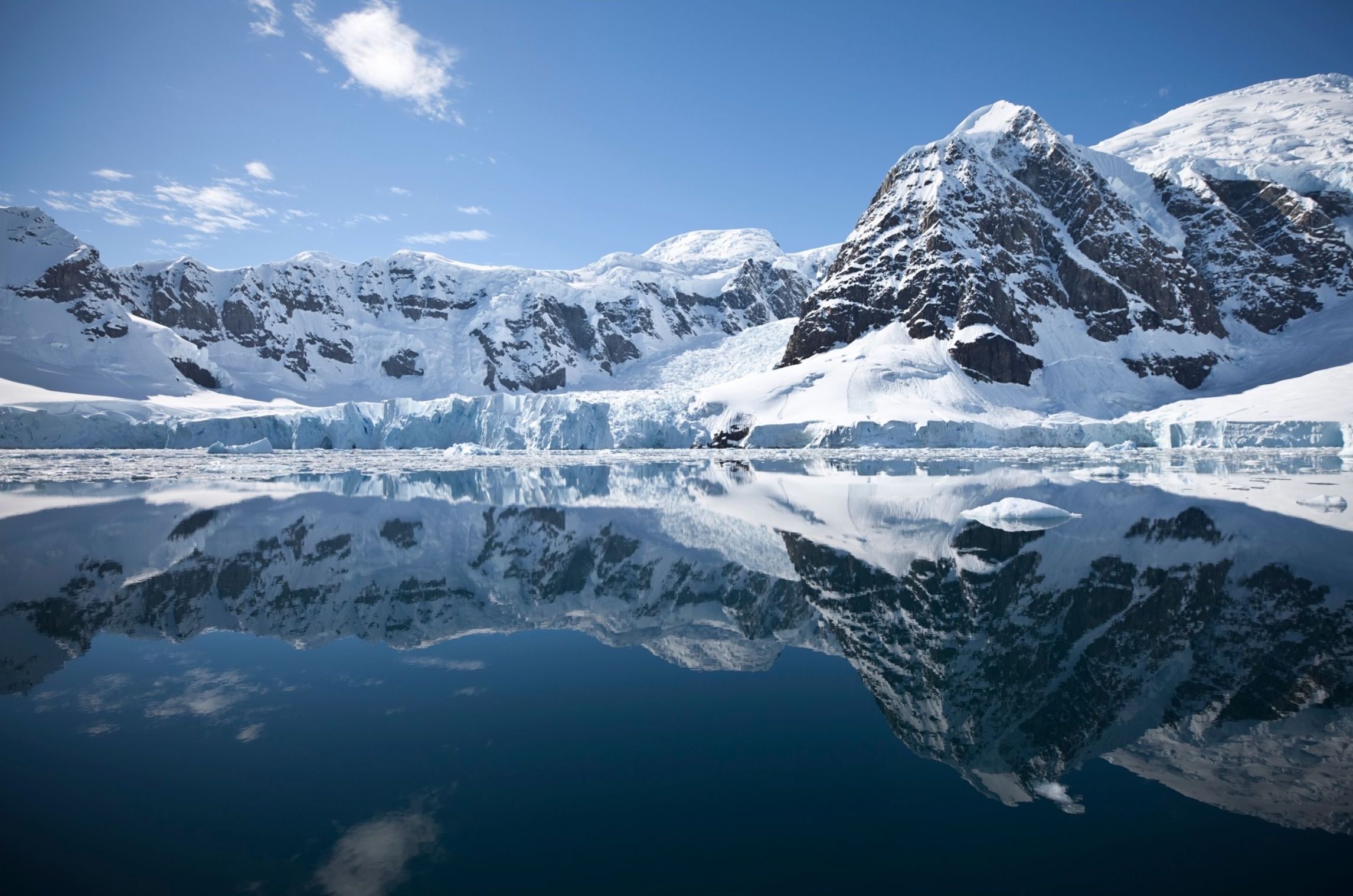 Mountains covered in ice and snow by the ocean
